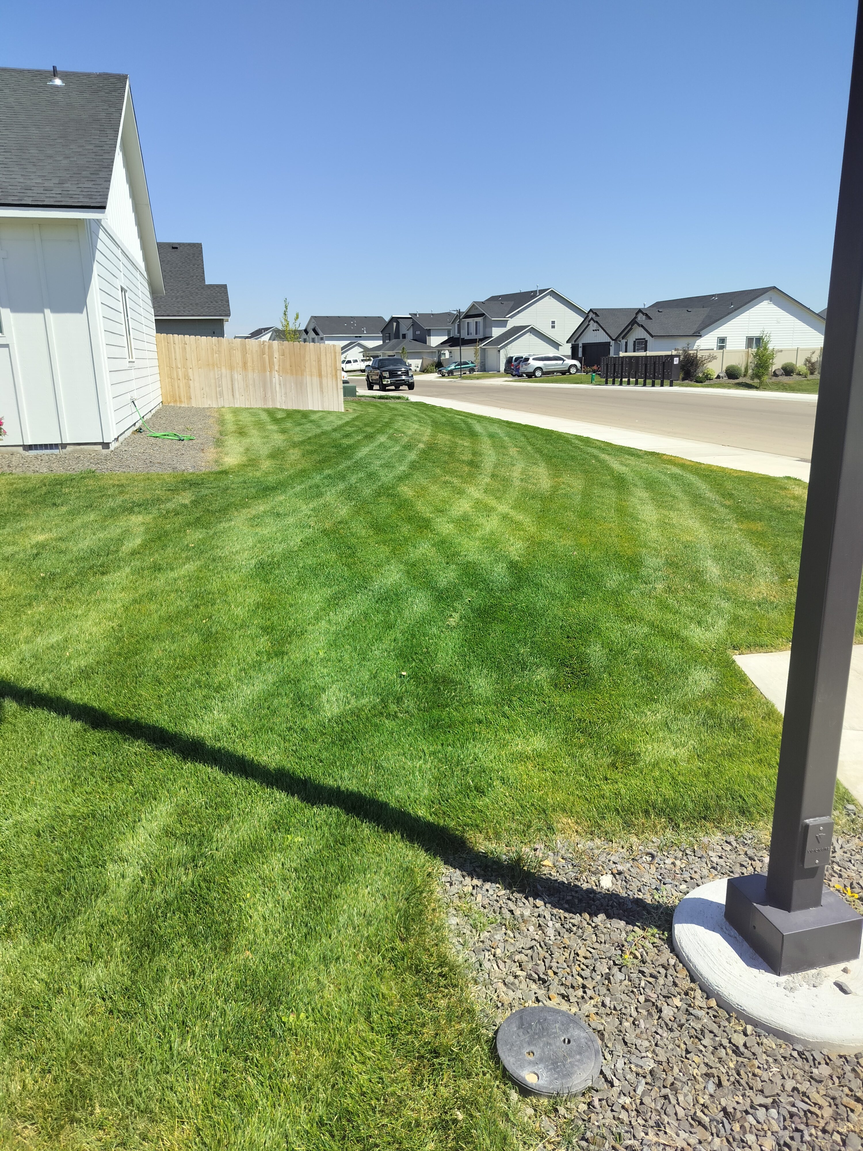 Neighborhood front lawn with fresh mowing lines by Green Grin